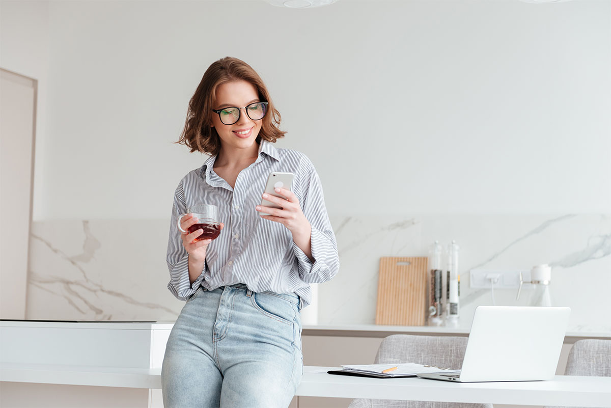 Frau die am Tisch lehnt und boxanize* CRM bedient